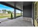 Spacious covered porch with stone accents, tasteful landscaping, and a gray exterior at 157 Palisade Ne Dr, Rydal, GA 30171