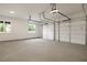Spacious three car garage with concrete floor, bright lighting, and access to the home and outside at 157 Palisade Ne Dr, Rydal, GA 30171
