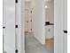 Hallway providing views into a bathroom space with white cabinets at 157 Palisade Ne Dr, Rydal, GA 30171