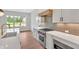Kitchen with granite countertops, tile backsplash, stainless steel appliances and large window for natural light at 157 Palisade Ne Dr, Rydal, GA 30171