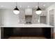 Modern kitchen island with stone countertop, pendant lights, and sleek design at 157 Palisade Ne Dr, Rydal, GA 30171
