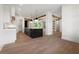 Bright, open kitchen with hardwood floors, island, and wood beam accents at 157 Palisade Ne Dr, Rydal, GA 30171