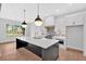 New kitchen with island, stainless steel appliances, granite countertops, tile backsplash and hardwood floors at 157 Palisade Ne Dr, Rydal, GA 30171