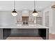 Modern kitchen featuring a large island, stainless steel appliances, pendant lights, and hardwood flooring at 157 Palisade Ne Dr, Rydal, GA 30171