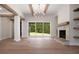 Spacious living room boasts stone fireplace, wooden beams, hardwood flooring and sliding doors at 157 Palisade Ne Dr, Rydal, GA 30171