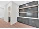 Stylish living area featuring built-in cabinets, natural wood shelves, and gray accent wall at 157 Palisade Ne Dr, Rydal, GA 30171