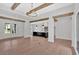 Bright, open floor plan with hardwood floors, exposed beams, a modern kitchen, and French doors at 157 Palisade Ne Dr, Rydal, GA 30171
