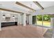 Open living room with hardwood floors, exposed beams, a modern kitchen and a sliding door at 157 Palisade Ne Dr, Rydal, GA 30171