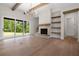 Bright living room featuring sliding doors, stone fireplace, hardwood flooring and open shelving at 157 Palisade Ne Dr, Rydal, GA 30171