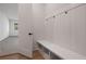 Clean mudroom with coat hooks, a built-in bench, and storage shelves, offering a convenient entry point at 157 Palisade Ne Dr, Rydal, GA 30171