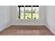 Empty room features a large window with a view of neighborhood homes and green landscape at 157 Palisade Ne Dr, Rydal, GA 30171