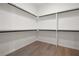 Spacious walk-in closet featuring multiple levels of shelving and hardwood floors at 157 Palisade Ne Dr, Rydal, GA 30171