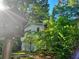 Exterior side view of a home with white siding and lots of trees at 161 E 78 Hwy, Temple, GA 30179