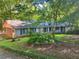 Charming single-story home with painted brick, well-maintained landscaping, and a covered carport at 161 E 78 Hwy, Temple, GA 30179
