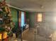 Well-lit living room featuring carpeted floors, green walls, and lots of natural light at 161 E 78 Hwy, Temple, GA 30179