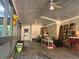 Spacious covered porch with ceiling fans and storage, ideal for relaxation and outdoor enjoyment at 161 E 78 Hwy, Temple, GA 30179
