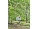 Outdoor storage shed nestled among lush greenery, providing ample space for tools and equipment at 161 E 78 Hwy, Temple, GA 30179