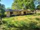 Spacious backyard with sliding glass doors and overgrown grass at 2579 Country Club Dr, Conyers, GA 30013