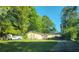 Ranch home with mature trees and a long driveway at 2579 Country Club Dr, Conyers, GA 30013