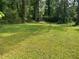 View of the grassy yard and surrounding trees of this homesite at 2903 Santa Barbara Dr, Decatur, GA 30032