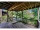 Back porch featuring a porch swing and a view of the lush backyard, perfect for outdoor enjoyment at 3391 Quail Hollow Trl, Snellville, GA 30039