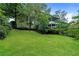 Backyard featuring a well-maintained lawn and lush landscaping, offering ample space for outdoor activities at 3391 Quail Hollow Trl, Snellville, GA 30039