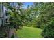 Backyard with grassy area and trees, providing a serene and private outdoor space at 3391 Quail Hollow Trl, Snellville, GA 30039