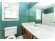 Outdated bathroom with green patterned wallpaper, a large mirror, and vanity sink at 3391 Quail Hollow Trl, Snellville, GA 30039