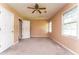 Bedroom with tan walls, carpet flooring, ceiling fan, and a window for natural light at 3391 Quail Hollow Trl, Snellville, GA 30039