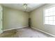 Bedroom with a ceiling fan, a window, and light-colored walls, ready for updates at 3391 Quail Hollow Trl, Snellville, GA 30039