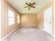 Bedroom with tan walls, carpet flooring, ceiling fan with a light fixture, and windows at 3391 Quail Hollow Trl, Snellville, GA 30039