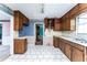 A spacious kitchen with wood cabinets, a double basin sink, and an open doorway for easy access at 3391 Quail Hollow Trl, Snellville, GA 30039