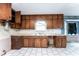 Outdated kitchen features wood cabinets, laminate countertops, a double basin sink, and white tile floors at 3391 Quail Hollow Trl, Snellville, GA 30039