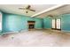Living room featuring a stone fireplace, ceiling fans, and glass doors at 3391 Quail Hollow Trl, Snellville, GA 30039