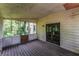 Enclosed porch with wood flooring and access to the outdoors, ideal for relaxation and entertaining at 3391 Quail Hollow Trl, Snellville, GA 30039