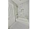Bathroom featuring new white bathtub and marble-style tile surround at 5464 Fox Haven Trl, Stone Mountain, GA 30088