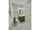 Well-lit bathroom with hexagon tile floors and grey vanity cabinet with storage at 5464 Fox Haven Trl, Stone Mountain, GA 30088