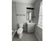 A beautifully renovated bathroom features a modern vanity, stylish lighting, and a glass-enclosed shower at 5464 Fox Haven Trl, Stone Mountain, GA 30088