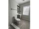 Modern bathroom with grey tiling, updated fixtures, and a bright window at 5464 Fox Haven Trl, Stone Mountain, GA 30088