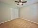 Comfortable bedroom with carpet, ceiling fan, and a double door closet at 5464 Fox Haven Trl, Stone Mountain, GA 30088