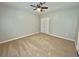Cozy carpeted bedroom with ceiling fan and double door closet at 5464 Fox Haven Trl, Stone Mountain, GA 30088