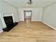 Bright living room featuring a fireplace, ceiling fan and light wood flooring at 5464 Fox Haven Trl, Stone Mountain, GA 30088