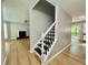 A newly renovated staircase with black treads, white risers, and light wood floors at 5464 Fox Haven Trl, Stone Mountain, GA 30088