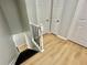 The staircase has black metal balusters, white wooden handrail and Luxury Vinyl Plank flooring at 5464 Fox Haven Trl, Stone Mountain, GA 30088