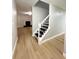 Elegant stairway with modern black and white accents and updated flooring at 5464 Fox Haven Trl, Stone Mountain, GA 30088