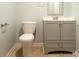 Bathroom features a toilet, vanity, and tile floor with trim at 679 Winchester Ln, Norcross, GA 30071