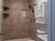 Tiled shower with shelves and dual shower heads, and a white medicine cabinet above the toilet at 679 Winchester Ln, Norcross, GA 30071