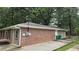 View of the exterior of the house featuring brick and siding along the side at 679 Winchester Ln, Norcross, GA 30071
