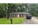 Cozy home with a charming brick facade and a well-kept lawn at 679 Winchester Ln, Norcross, GA 30071