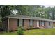 Charming one-story home featuring a brick facade and well-maintained landscaping at 679 Winchester Ln, Norcross, GA 30071